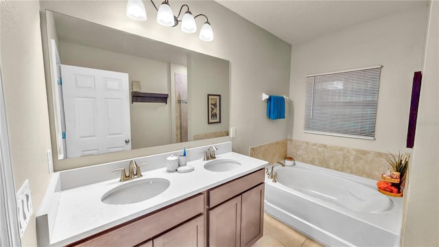 bathroom with tile patterned flooring, vanity, and a bathtub