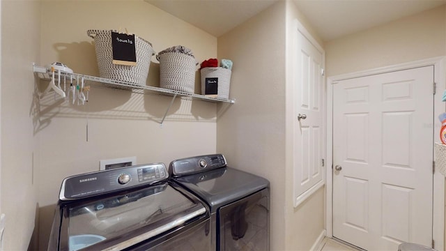 clothes washing area with washer and clothes dryer