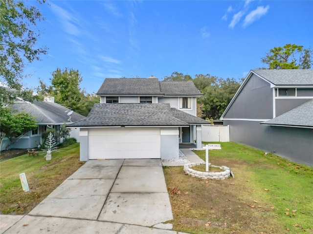 view of property with a front lawn and a garage