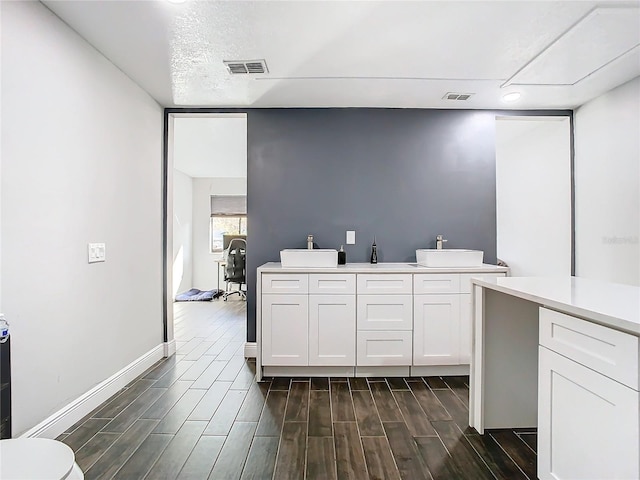 kitchen featuring white cabinets and sink