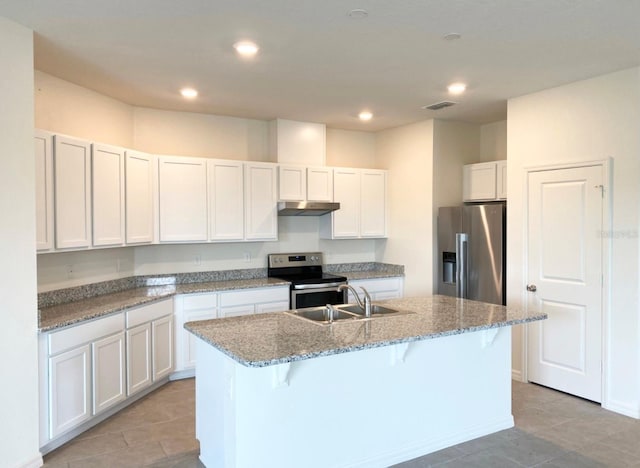 kitchen featuring a kitchen breakfast bar, sink, an island with sink, and stainless steel appliances