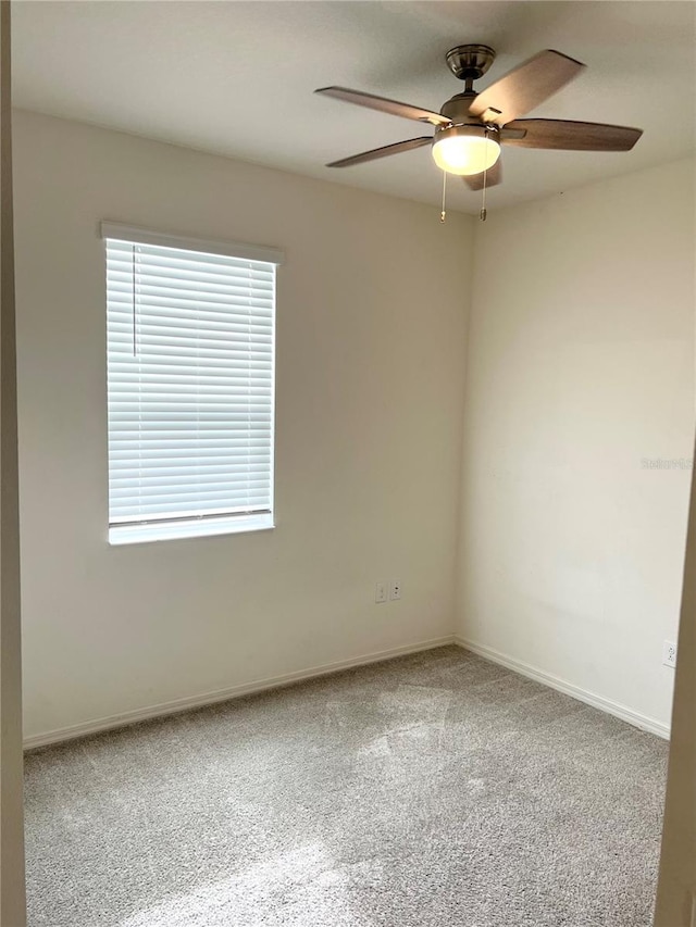 spare room featuring carpet flooring and ceiling fan