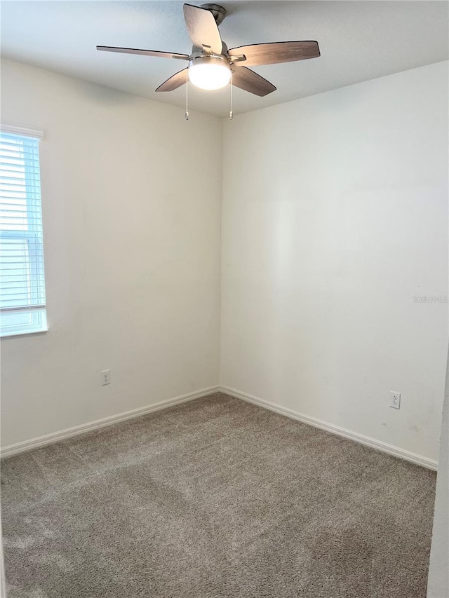 empty room featuring carpet flooring and ceiling fan