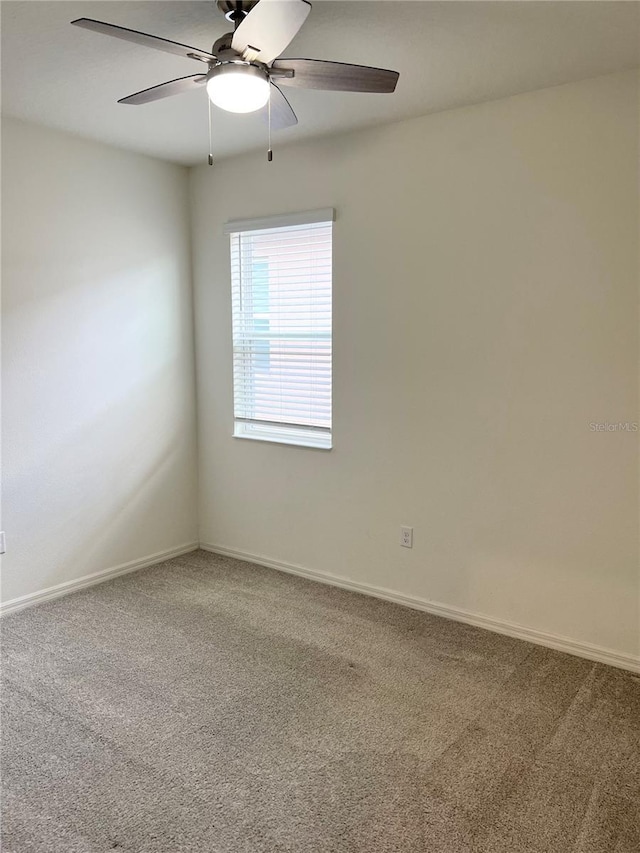 carpeted empty room with ceiling fan