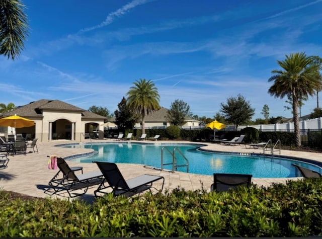 view of pool featuring a patio area and a hot tub