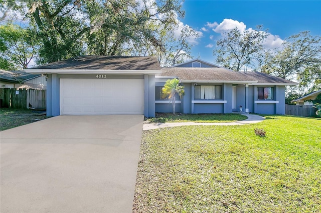 ranch-style home featuring a front lawn and a garage