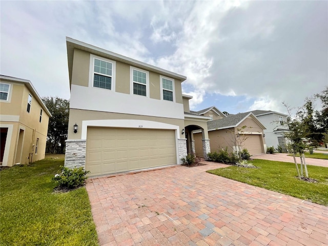 view of front of home featuring a front yard and a garage