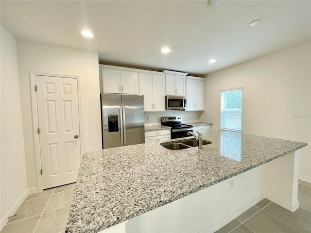 kitchen featuring a spacious island, sink, white cabinetry, and stainless steel appliances