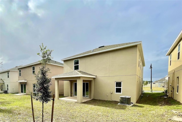 back of house featuring a yard, a patio, and cooling unit