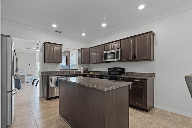 kitchen with crown molding, a kitchen island, stainless steel appliances, and light tile patterned floors