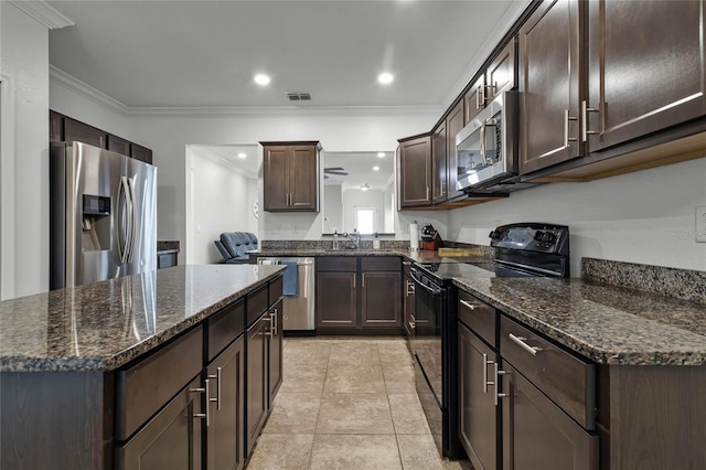 kitchen with stainless steel appliances, dark stone countertops, crown molding, dark brown cabinets, and light tile patterned flooring