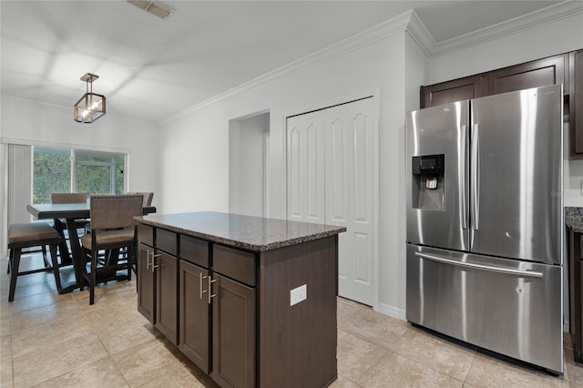 kitchen with stainless steel fridge, dark brown cabinetry, and crown molding