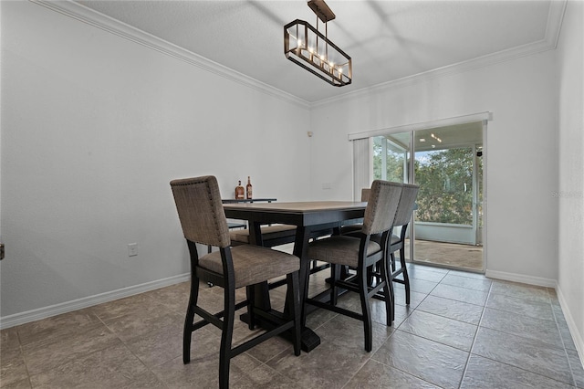 dining space featuring ornamental molding and a notable chandelier