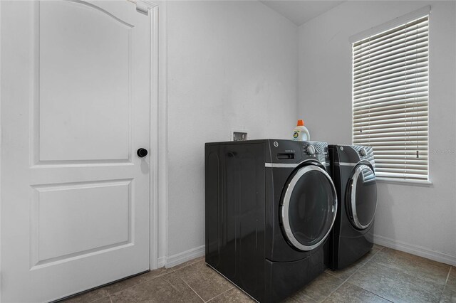 laundry area with tile patterned floors and independent washer and dryer