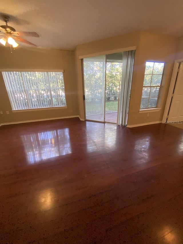 empty room featuring ceiling fan and a wealth of natural light