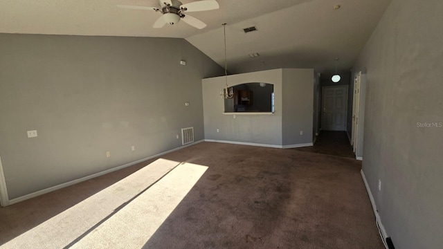 unfurnished living room with dark colored carpet, vaulted ceiling, and ceiling fan