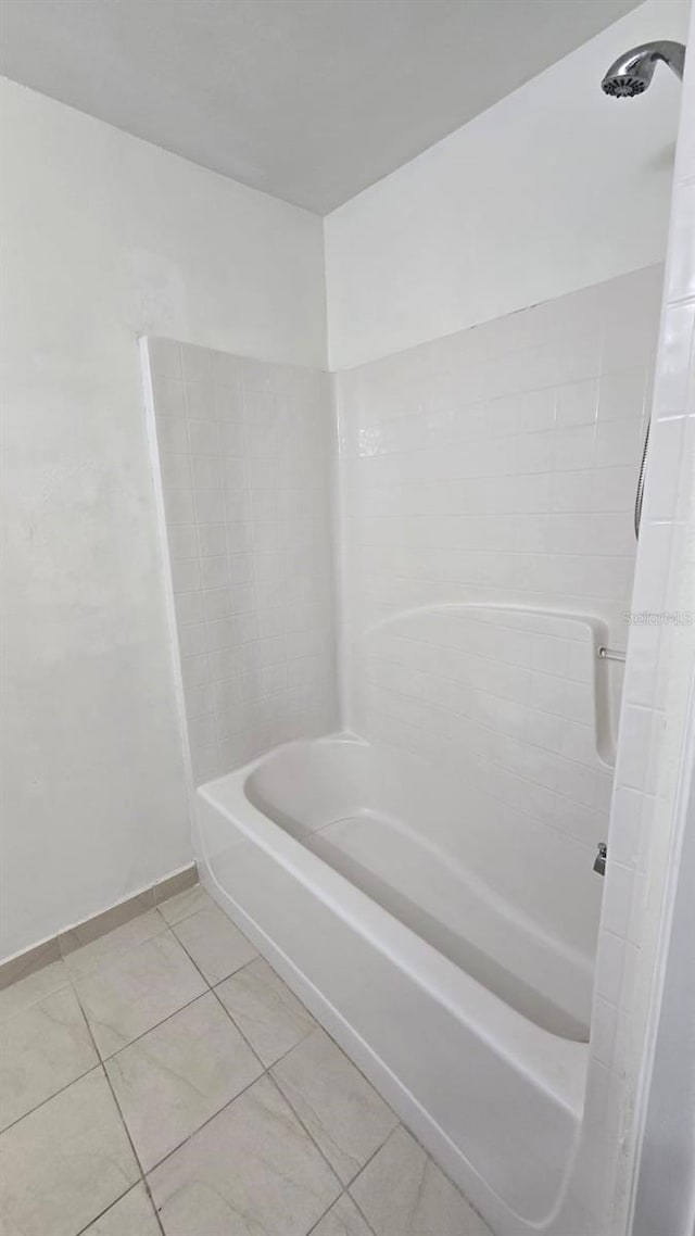 bathroom featuring tile patterned flooring and  shower combination