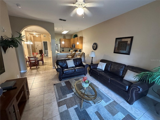 living room featuring light tile patterned floors and ceiling fan