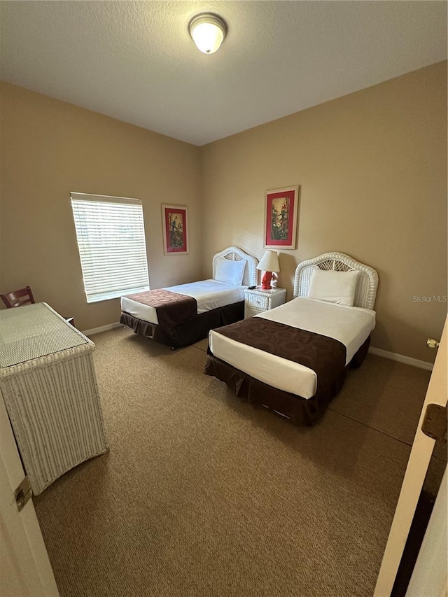 bedroom featuring a textured ceiling and carpet floors