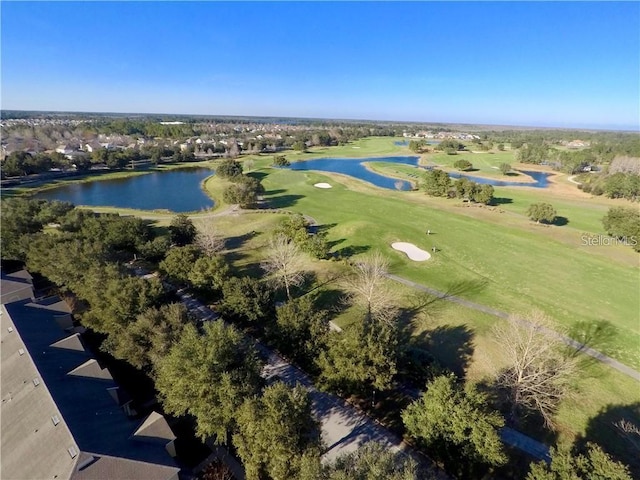 aerial view with golf course view and a water view