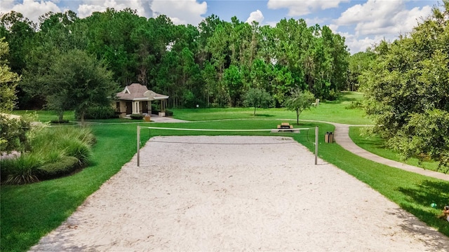 view of property's community with a yard and volleyball court