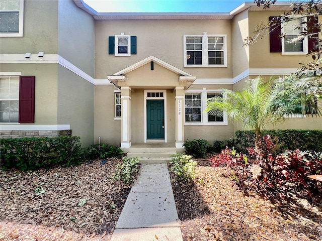 entrance to property featuring stucco siding