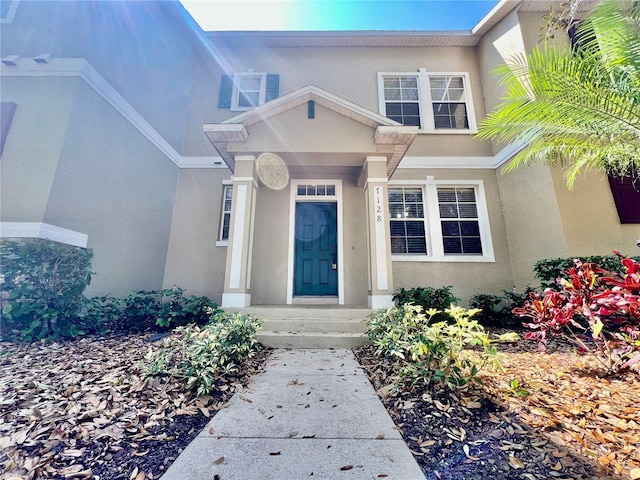 entrance to property with stucco siding