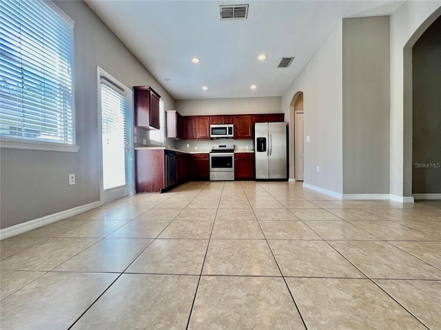 kitchen with light countertops, light tile patterned floors, visible vents, and stainless steel appliances