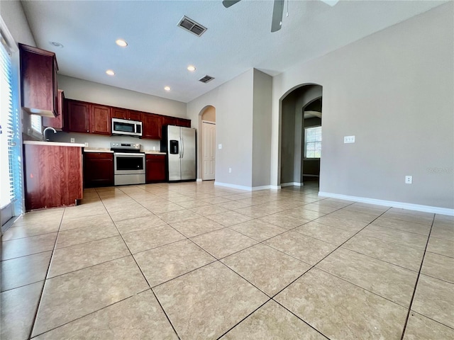 kitchen with light countertops, light tile patterned flooring, visible vents, and appliances with stainless steel finishes