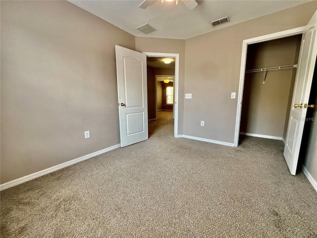 unfurnished bedroom with visible vents, a closet, carpet floors, baseboards, and ceiling fan