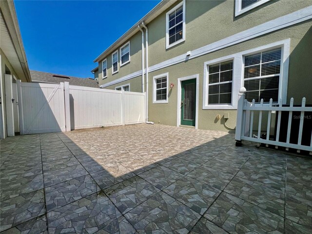 view of patio with a gate and fence