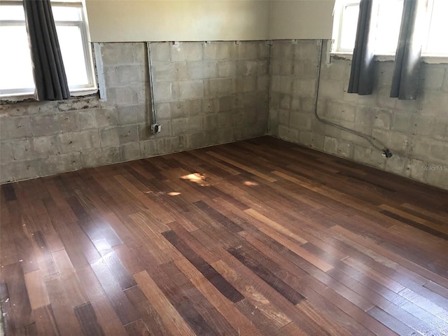 empty room featuring dark hardwood / wood-style floors and a healthy amount of sunlight