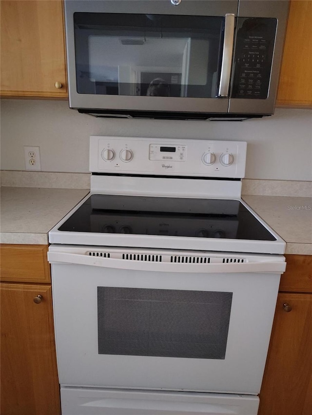 kitchen featuring white range with electric cooktop