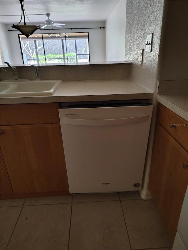 kitchen featuring ceiling fan, sink, white dishwasher, and light tile patterned flooring