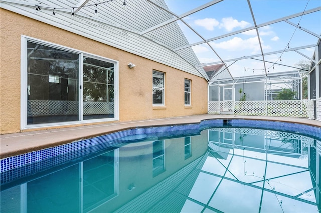 view of pool with glass enclosure