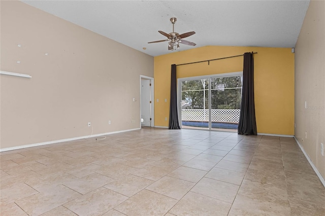 spare room featuring ceiling fan, lofted ceiling, a textured ceiling, and light tile patterned floors