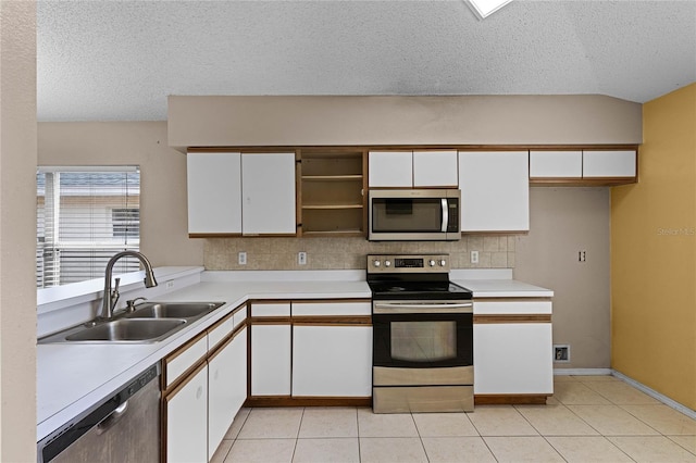 kitchen with backsplash, sink, white cabinetry, and stainless steel appliances