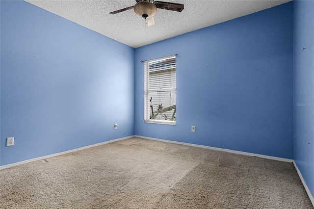 carpeted empty room with ceiling fan and a textured ceiling