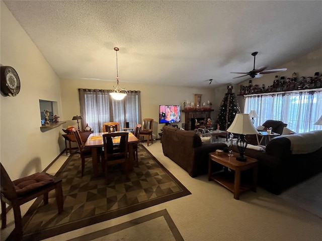 carpeted dining area featuring a textured ceiling and ceiling fan