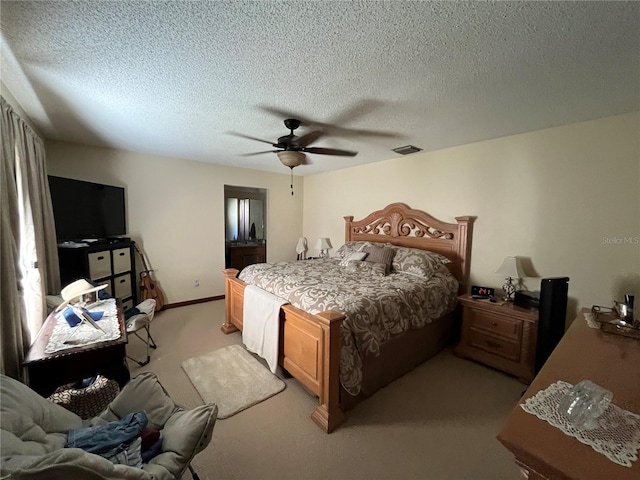 carpeted bedroom with ceiling fan and a textured ceiling