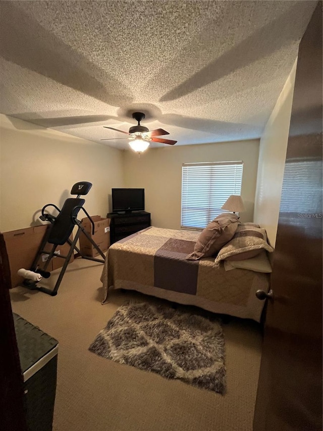 bedroom with carpet flooring, ceiling fan, and a textured ceiling