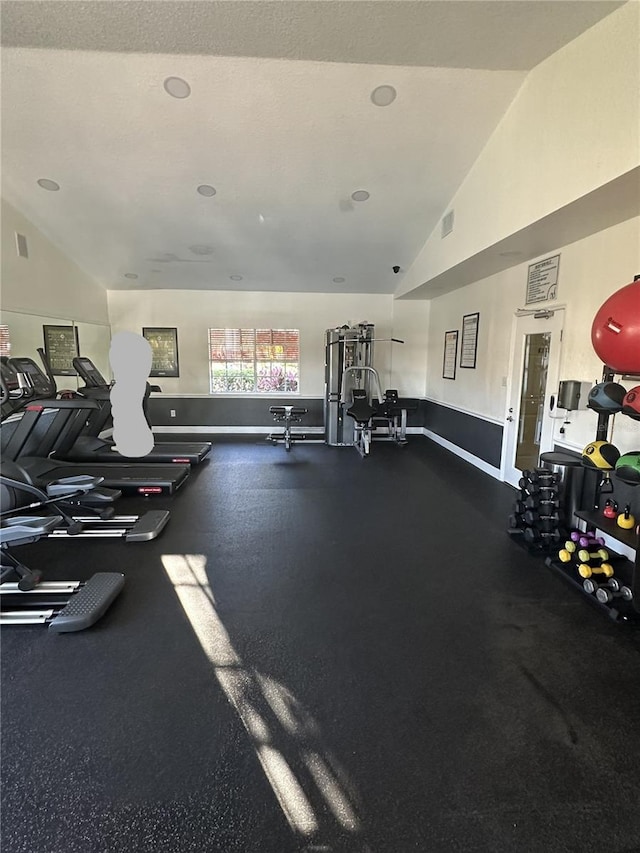 exercise room with vaulted ceiling