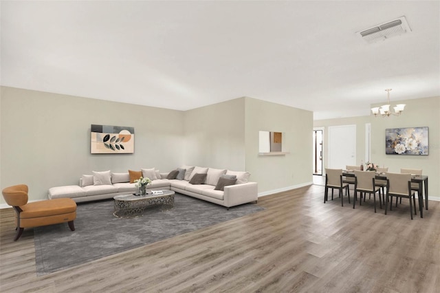 living room with a chandelier and hardwood / wood-style flooring