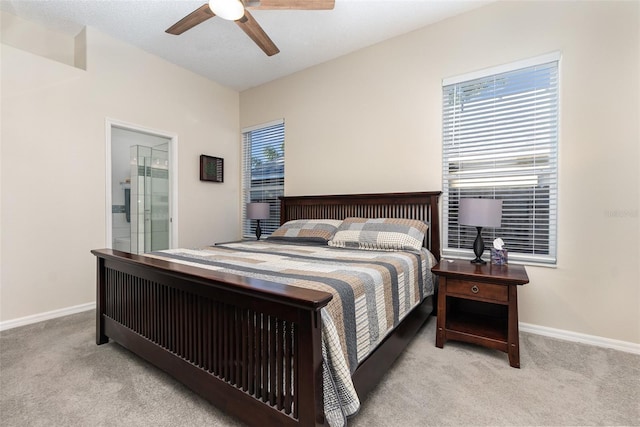 carpeted bedroom featuring ensuite bath and ceiling fan