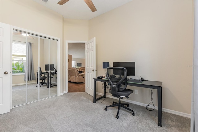 carpeted office with ceiling fan