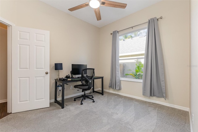 carpeted home office featuring ceiling fan