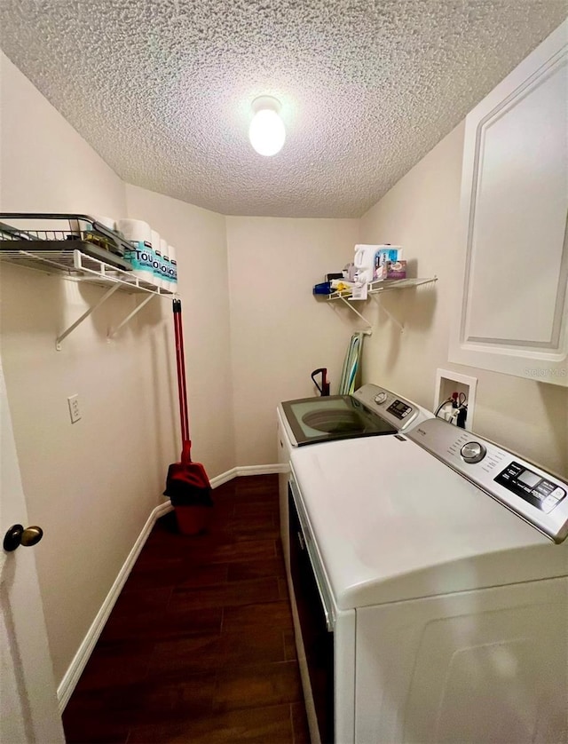 washroom featuring independent washer and dryer, dark hardwood / wood-style flooring, and a textured ceiling