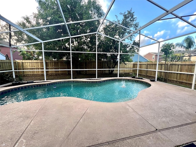 view of swimming pool with glass enclosure and a patio area