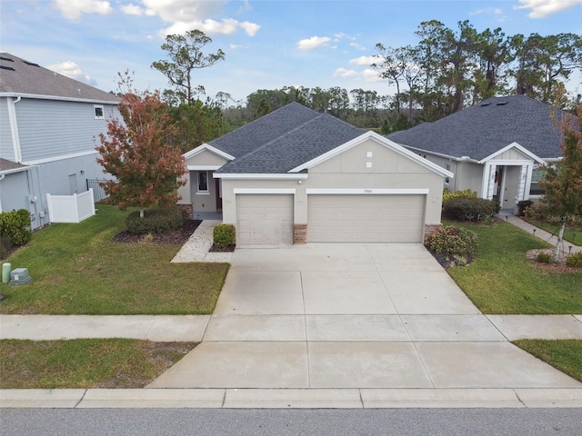 single story home featuring concrete driveway, roof with shingles, an attached garage, fence, and a front yard