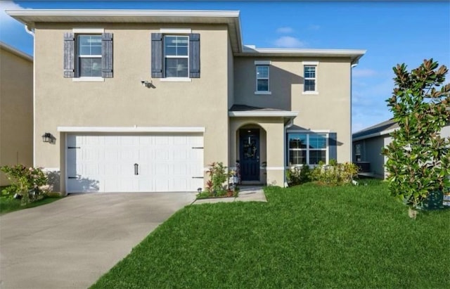 view of front of property with a garage and a front lawn